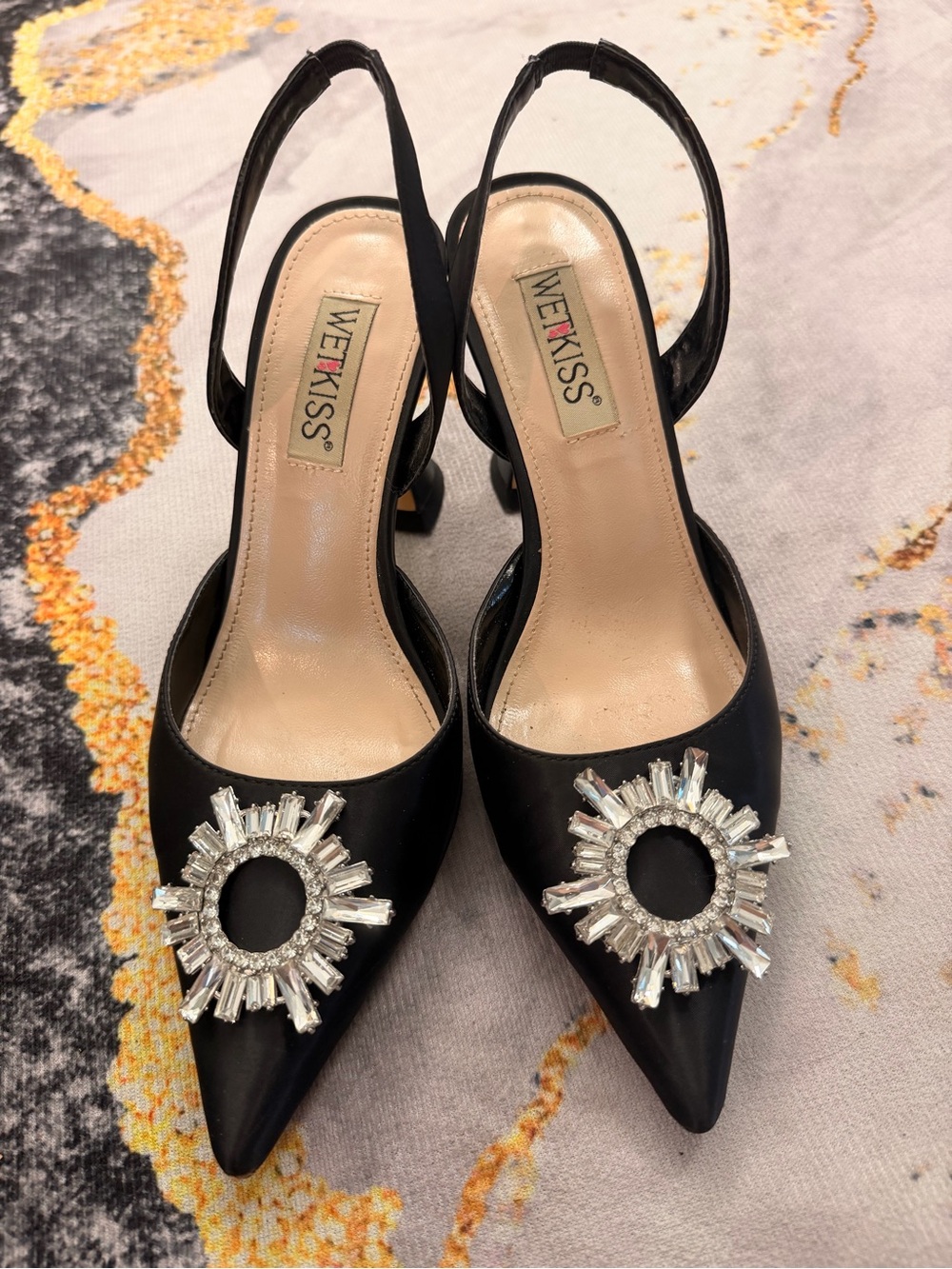 WET KISS Black Pointed Slingback Heels with Crystal Sunburst Accent
